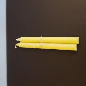 Bundle of golden yellow dinner candles